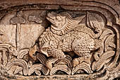 Chiang Mai - The Wat Phra Singh temple. The ho trai (temple library). The stucco figures in high relief decorationg the base. 